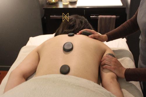 Femme se faisant faire un massage aux pierres chaudes